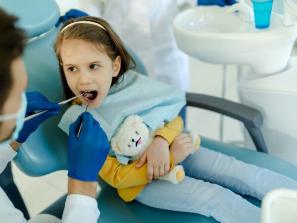 little-girl-is-not-afraid-to-show-teeth-to-dentist-2025-01-09-07-47-54-utc smiling girl at dental checkups & cleanings